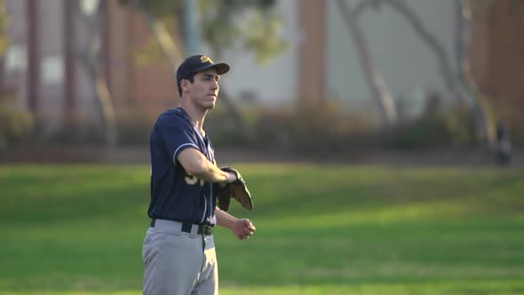 A young man playing catch with a baseball.