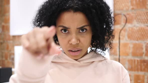 AfroAmerican Woman Pointing at Camera in Office