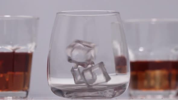 Pouring Whiskey Into The Glass with Ice