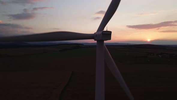 Silhouette of Windmill Turbine in Field at Sunset Sky