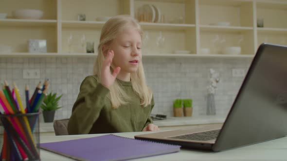 Adorable Girl with Hearing Loss Speaking with Sign Language During Video Call