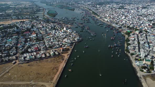 Majestic fisherman town of Phan Ri Cua with many moored fishing boats, aerial