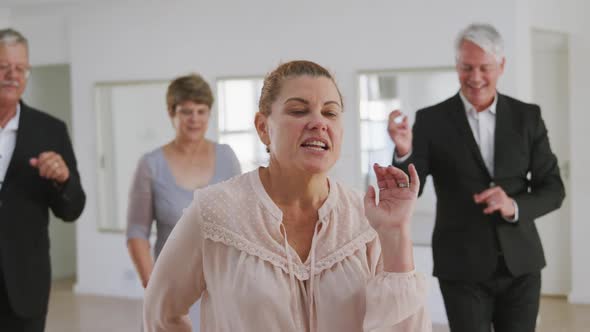 Caucasian senior couple spending time together dancing in a ballroom