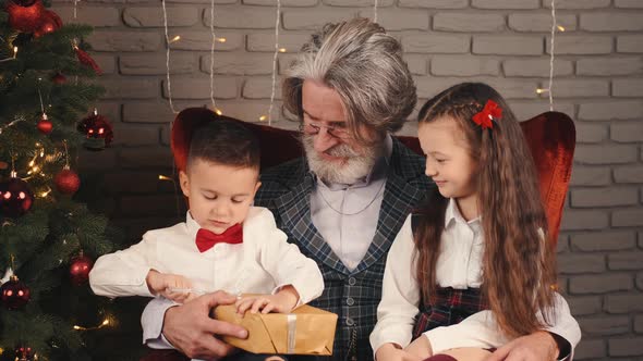 Grandfather and Kids with Christmas Gifts