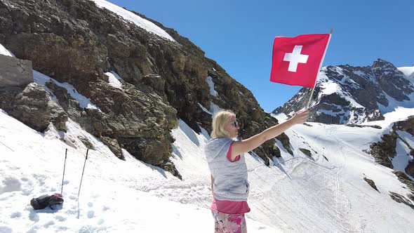 Woman on Diavolezza with Swiss Flag