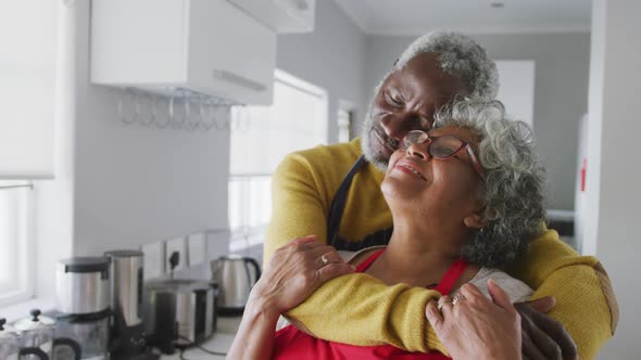 A senior african american couple spending time together in love social distancing in quarantine.