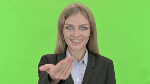 Cheerful Businesswoman Inviting By Hand Sign Against Chroma Key
