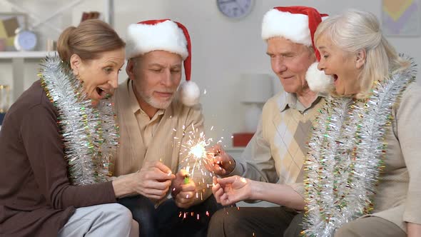 Excited Pensioners in Santa Hats Lighting Bengal Light, New Year Celebration