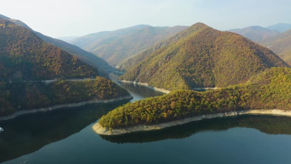 Aerial View of Mountain Lake Surrounded by Autumn Forest, circle pan