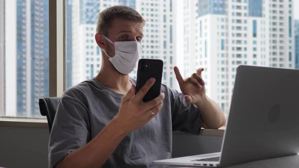 Office Worker in a Face Mask Having an Online Business Meeting Discussing New Project