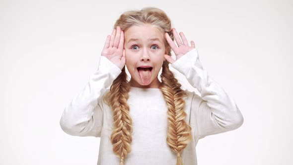 Very Young Beautiful Caucasian Girl with Blonde Long Hair Standing with Face Covered with Hands and