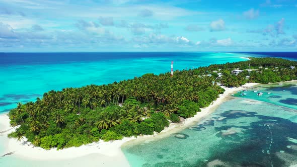 Wide above travel shot of a white sandy paradise beach and aqua blue water background in high resolu