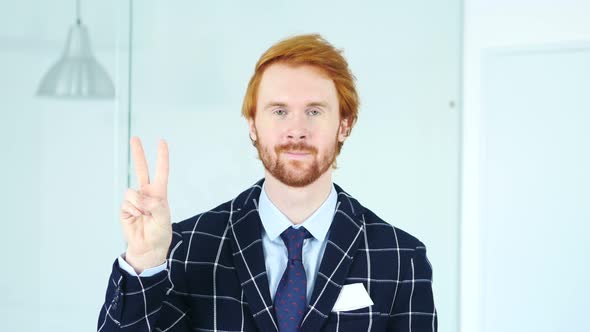 Victory Sign by Beard Redhead Businessman in Office