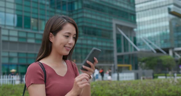 Woman Use of Mobile Phone Online at Outdoor