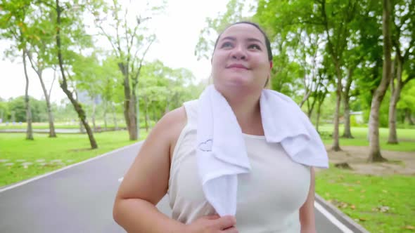 Overweight young woman exercising to lose weight in the park