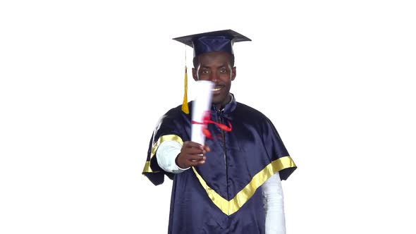 Student with Graduation Gown and Diplom. Slow Motion. White