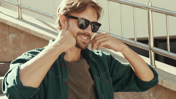 Portrait of young handsome man posing outdoors