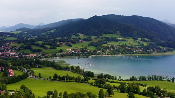 Panning shot over the Tegernsee, a popular recreation aera lake with the aerial view from Gmund over