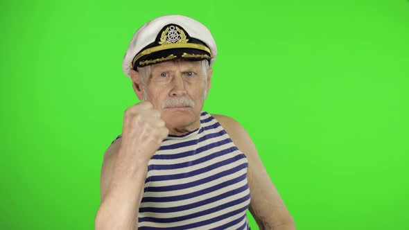 Elderly Sailor Man Is Angry and Shows a Fist. Sailorman on Chroma Key Background