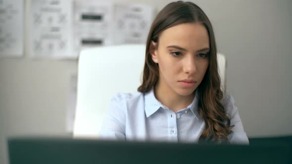 Beautiful Businesswoman Working on Her Laptop While Sitting at Office