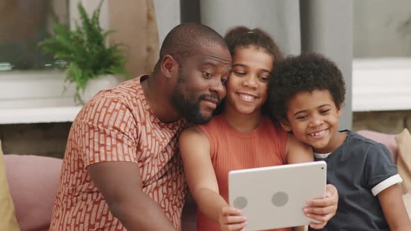 Afro Siblings Taking Selfie With Dad At Home