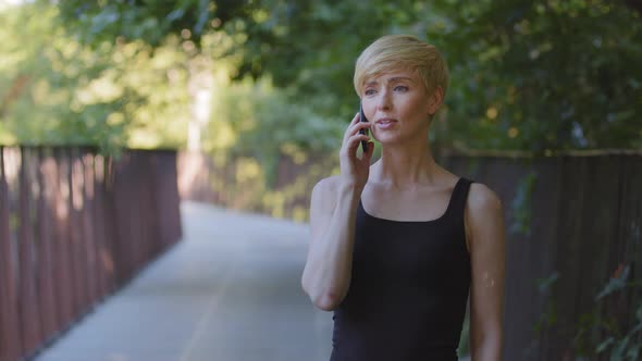 Portrait Outdoors Caucasian Woman Short Haired Female Blonde Middle Aged Lady Talking on Mobile