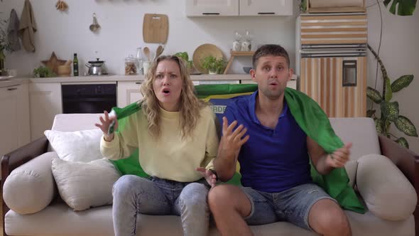 Family Couple of Sports Fans at Home with Brazil Flag