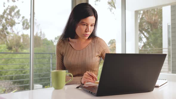 Woman working from home on her laptop