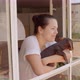 Young Dark Hair Woman Smile and Bring Her Dog to See Out of the Window - VideoHive Item for Sale