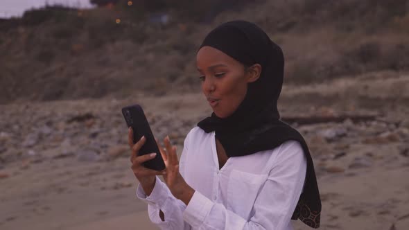 Somali-American woman checking her social media