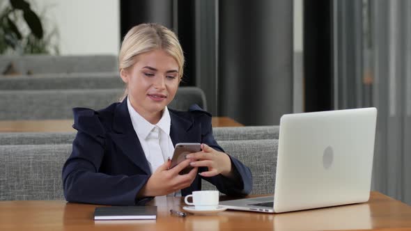 Woman Office Worker Makes Calls at Lunchtime