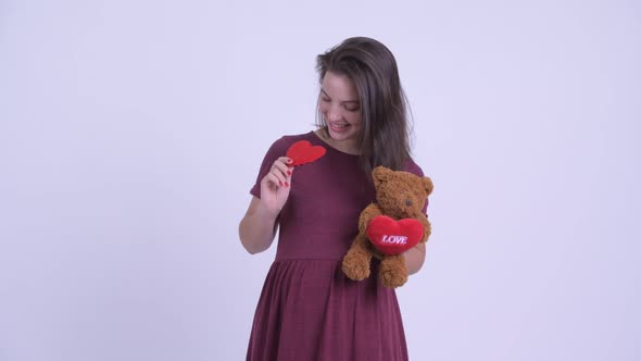 Happy Young Beautiful Pregnant Woman Holding Red Heart and Teddy Bear