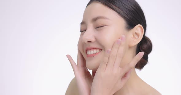 Close Up Of Young Beautiful Asian Woman Touch Her Face Gently With Fingertips.