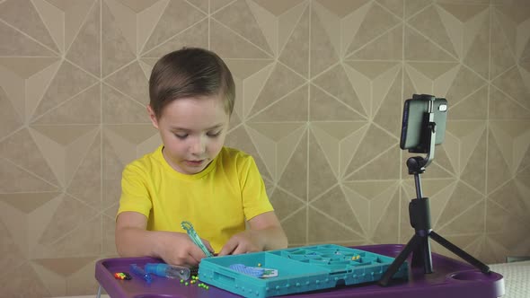 Boy Leads a Video Blog for Children with a Smartphone on a Tripod. Production of Children's Content