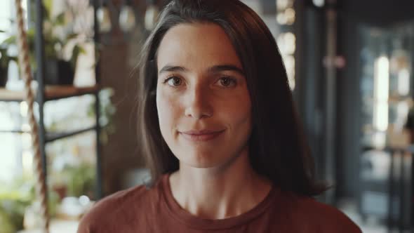 Portrait of Smiling Brunette Woman in Cafe