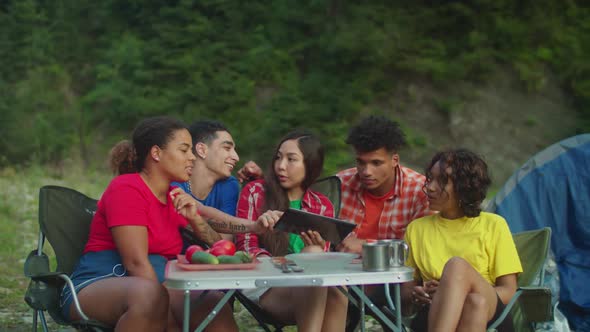 Cheerful Diverse Multiracial Backpackers Enjoying Leisure Together at Camping Trip
