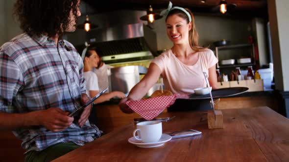 Waitress serving food to customer