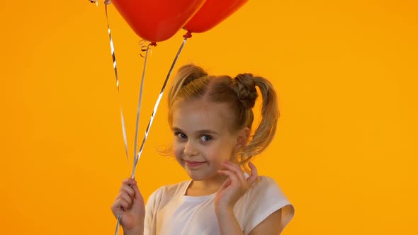 Little Coquette Girl With Balloons Sending Air Kiss on Camera, First Sympathy