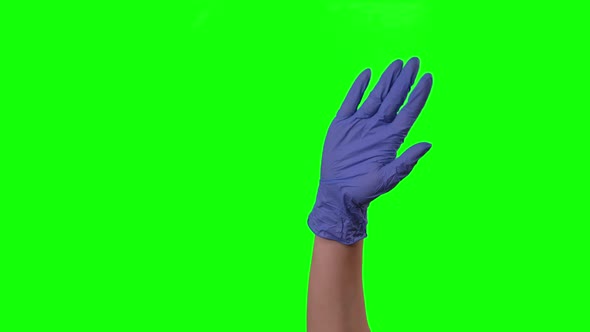 Doctor's Female Hand in Blue Glove Is Waving Welcoming You Against a Green Screen Background