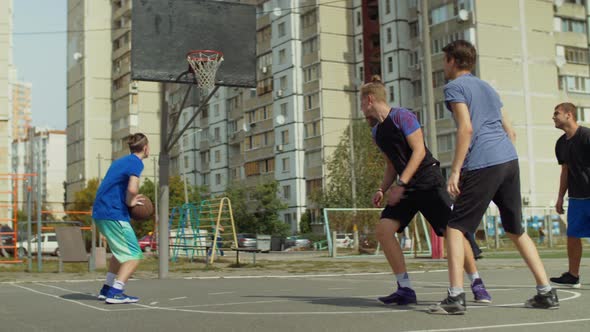 Streetball Players Passing the Ball on Court