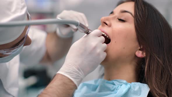 Woman Patient with Toothache During Treatment Tooth at Stomatology Clinic