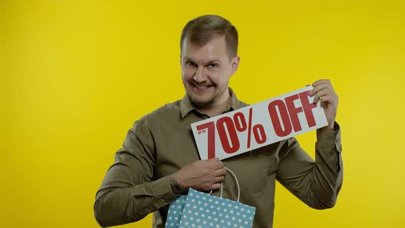 Joyful Man Showing Up To 70 Percent Off Inscription From Shopping Bag, Smiling, Rejoicing Discount