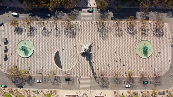 Aerial Overhead Top Down Birds Eye View of People Walking Around Large Public Square with Water