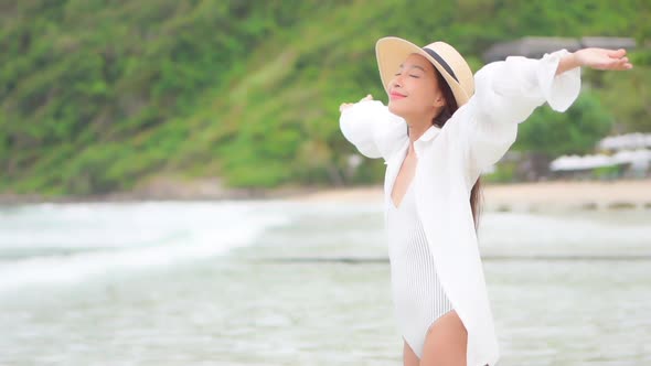 Asian woman enjoy around beautiful beach sea ocean