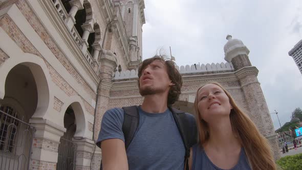 Young Man and Woman Walking Around the Sultan Abdul Samad Building in Kuala Lumpur Vity, Malaysia