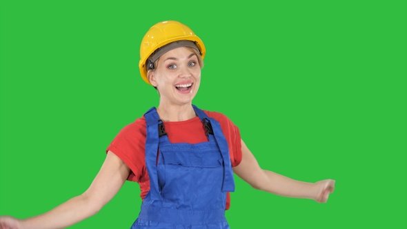 Female construction worker dancing happy on a Green Screen