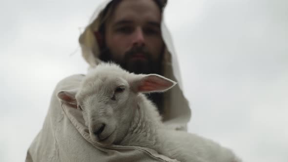 Jesus Christ Face From The Bible Holding A Lamb