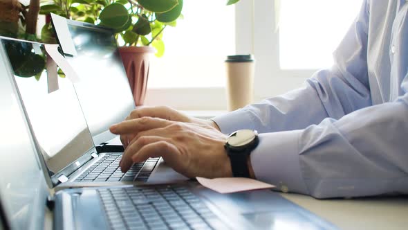 A Business Analyst is Working with Three Laptops