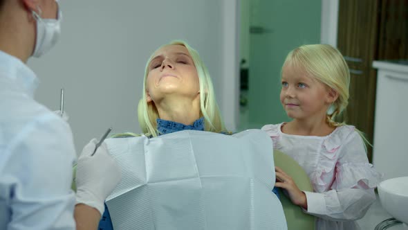 Happy Mother and Daughter in the Dental Clinic