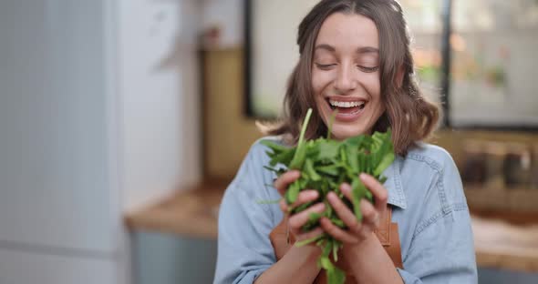 Housewife Enjoying Fresh Spinac While Cooking